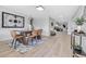 Modern dining room featuring a wooden table with tan chairs, a patterned rug, and light wood floors at 4624 83Rd Terrace N, Pinellas Park, FL 33781
