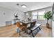 Bright dining room with wood table, tan chairs, patterned rug, light wood floors, and greenery at 4624 83Rd Terrace N, Pinellas Park, FL 33781