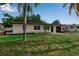 Single-story home with well-maintained lawn and landscaping, plus fresh exterior paint and a dark driveway at 4624 83Rd Terrace N, Pinellas Park, FL 33781