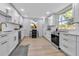 Bright, modern kitchen featuring white cabinets, stainless steel appliances, and gold hardware at 4624 83Rd Terrace N, Pinellas Park, FL 33781