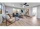 Bright living room featuring a modern ceiling fan, sleek furniture, and large windows for ample natural light at 4624 83Rd Terrace N, Pinellas Park, FL 33781
