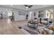 Spacious living room with light wood floors, stylish furnishings, and a large window providing ample natural light at 4624 83Rd Terrace N, Pinellas Park, FL 33781