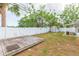 Backyard with a wooden deck, a storage shed and a white fence at 4714 W Lawn Ave, Tampa, FL 33611