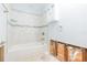 Bright bathroom featuring a white bathtub and tiled walls with a decorative blue accent strip at 4714 W Lawn Ave, Tampa, FL 33611
