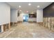 Bright open-concept room awaiting remodel with an entryway to the kitchen at 4714 W Lawn Ave, Tampa, FL 33611