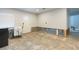 Spacious room awaiting remodel with white walls, recessed lighting, and new back door at 4714 W Lawn Ave, Tampa, FL 33611
