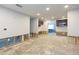 Open-concept room awaiting remodel with white walls, recessed lighting, and bar at 4714 W Lawn Ave, Tampa, FL 33611