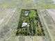 Aerial view of the property showing home, pond, and the surrounding land in a red outline at 4858 Troydale Rd, Tampa, FL 33615