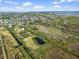 Aerial view of the property with a pond, marsh area, cityscape and Gulf of Mexico in the background at 4858 Troydale Rd, Tampa, FL 33615