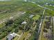 Aerial view of property highlighting the home, pond, and lush greenery at 4858 Troydale Rd, Tampa, FL 33615