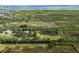 An aerial view of a property featuring a pond and surrounding greenery near a tranquil body of water at 4858 Troydale Rd, Tampa, FL 33615