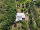 Aerial view of the home surrounded by dense trees on a large, private lot at 4858 Troydale Rd, Tampa, FL 33615