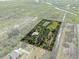 Aerial view of property highlighting the home, pond, and lush greenery at 4858 Troydale Rd, Tampa, FL 33615