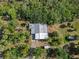 An aerial view of the property highlighting its unique landscaping and secluded atmosphere provided by the surrounding trees at 4858 Troydale Rd, Tampa, FL 33615