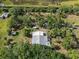 Overhead view showing home location amongst grassy space, tropical trees, and other structures on lot at 4858 Troydale Rd, Tampa, FL 33615