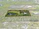 A bird's eye view of boundary showcasing home site with pond and mature foliage, creating a tranquil oasis at 4858 Troydale Rd, Tampa, FL 33615