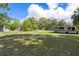 Spacious backyard with ample space, featuring a vintage RV and potential for various outdoor activities and landscaping at 4858 Troydale Rd, Tampa, FL 33615