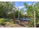 Backyard area featuring access to a calm body of water, surrounded by lush greenery and natural beauty at 4858 Troydale Rd, Tampa, FL 33615