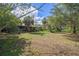Expansive backyard with mature trees, offering plenty of space for recreation and potential landscaping opportunities at 4858 Troydale Rd, Tampa, FL 33615