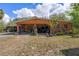 Inviting single-story home with a large covered carport and well-maintained landscaping, creating a welcoming curb appeal at 4858 Troydale Rd, Tampa, FL 33615