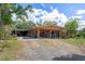 Charming single-story home with a spacious driveway and lush landscaping, providing a tranquil setting at 4858 Troydale Rd, Tampa, FL 33615