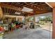 Spacious garage with high ceilings and ample room for storage and projects, featuring a variety of tools and equipment at 4858 Troydale Rd, Tampa, FL 33615