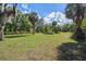 Spacious and well-maintained grassy grounds featuring mature trees and a trailer at 4858 Troydale Rd, Tampa, FL 33615