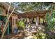 Shady open air outdoor patio with a rustic aesthetic and garden views at 4858 Troydale Rd, Tampa, FL 33615
