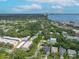 Impressive aerial view highlights a neighborhood with lush trees, bay views, and cityscape, showcasing the community's beauty at 5015 S Elberon St, Tampa, FL 33611