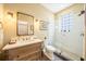 Bathroom featuring a glass shower, stone floors, and a rustic vanity at 5015 S Elberon St, Tampa, FL 33611