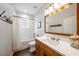 Bathroom featuring single vanity, wooden cabinets, modern fixtures, and a shower and tub combo at 5015 S Elberon St, Tampa, FL 33611