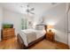 Bedroom featuring white walls, ceiling fan, neutral tones, and wood flooring at 5015 S Elberon St, Tampa, FL 33611