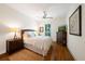 Bright bedroom showcases hardwood floors, ceiling fan, TV, and large window at 5015 S Elberon St, Tampa, FL 33611