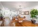 Cozy dining area with hardwood floors, stylish light fixture, and seamless flow to the modern kitchen at 5015 S Elberon St, Tampa, FL 33611