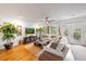 Open living room with wood floors, comfy seating, and large windows for ample natural light at 5015 S Elberon St, Tampa, FL 33611