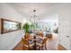Bright living room featuring hardwood floors, a dining area, natural lighting, and neutral colored furnishings at 5015 S Elberon St, Tampa, FL 33611