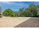 Expansive brick parking area surrounded by lush greenery and mature trees, providing ample space at 5015 S Elberon St, Tampa, FL 33611
