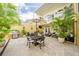 Beautiful screened patio features an outdoor dining area, lounge furniture, lush plants, and tiled flooring, perfect for relaxing at 5015 S Elberon St, Tampa, FL 33611