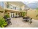 Stylish screened patio boasts an outdoor dining set, lounge furniture, a balcony, and tile flooring for the ultimate relaxation at 5015 S Elberon St, Tampa, FL 33611