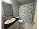 Cozy bathroom features a shower and a sink with black countertop, bright natural lighting at 5173 Kirkland Ave, Spring Hill, FL 34606
