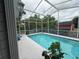 Enjoy the outdoors in this screened-in pool with clear blue water and plenty of space to lounge around at 5173 Kirkland Ave, Spring Hill, FL 34606