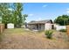 View of home's backyard, fence, and screened-in back porch at 5213 Burr Pl, Seffner, FL 33584