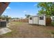 Backyard featuring a shed, brick home, fence, and screened in back porch at 5213 Burr Pl, Seffner, FL 33584