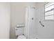 Bright bathroom featuring tiled shower, grab bar, and updated fixtures for safety and convenience at 5213 Burr Pl, Seffner, FL 33584
