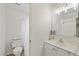 Bright bathroom featuring a toilet, shower with curtain, and a sink with storage at 5213 Burr Pl, Seffner, FL 33584