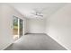 Bright bedroom with ceiling fan, neutral walls, and sliding glass door leading outdoors at 5213 Burr Pl, Seffner, FL 33584