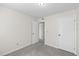 A simple bedroom with neutral walls, gray carpet, and closet at 5213 Burr Pl, Seffner, FL 33584