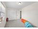 Well-lit bedroom with gray carpet, white closet, and a play tunnel on the floor at 5213 Burr Pl, Seffner, FL 33584