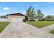 Single-story home with a well-kept lawn, mature tree, and an attached one-car garage at 5213 Burr Pl, Seffner, FL 33584