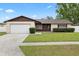 Charming one-story home with a well-maintained lawn and attached one car garage at 5213 Burr Pl, Seffner, FL 33584